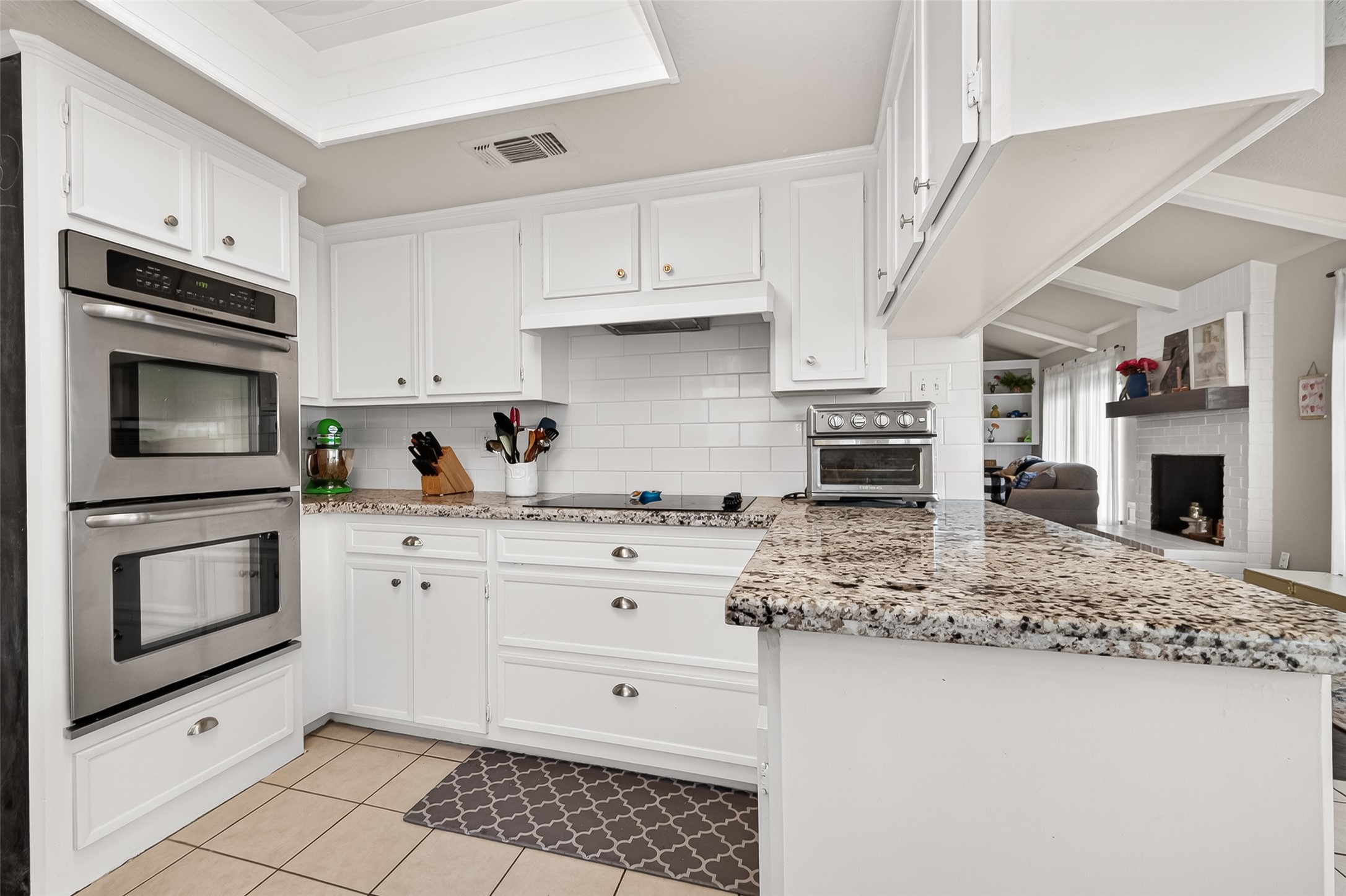 17611 Sorrell Ridge Drive Spring, TX 77388 - Photo 23 of 50 a kitchen with kitchen island granite countertop a stove sink and microwave