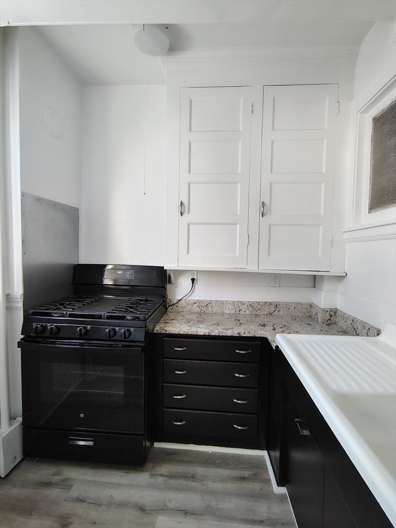 1 Harbor Street, Unit 3 Salem, MA 01970 - Photo 2 of 10 a kitchen with granite countertop a stove and a sink