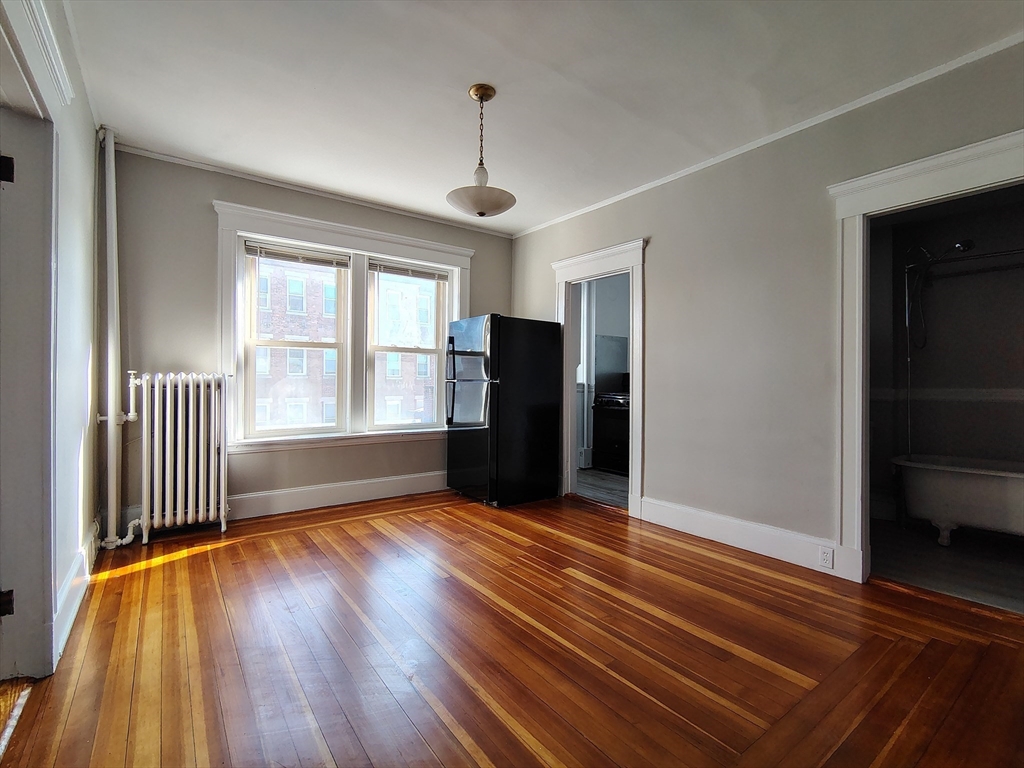 1 Harbor Street, Unit 3 Salem, MA 01970 - Photo 3 of 10 an empty room with wooden floor and windows