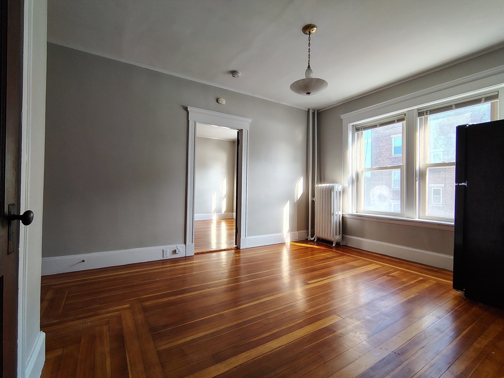 1 Harbor Street, Unit 3 Salem, MA 01970 - Photo 5 of 10 a view of empty room with wooden floor and fan