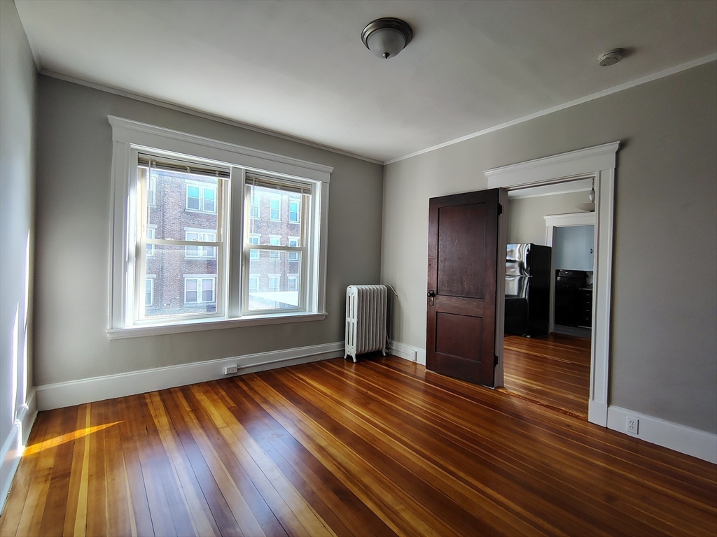1 Harbor Street, Unit 3 Salem, MA 01970 - Photo 7 of 10 a view of empty room with wooden floor and fan