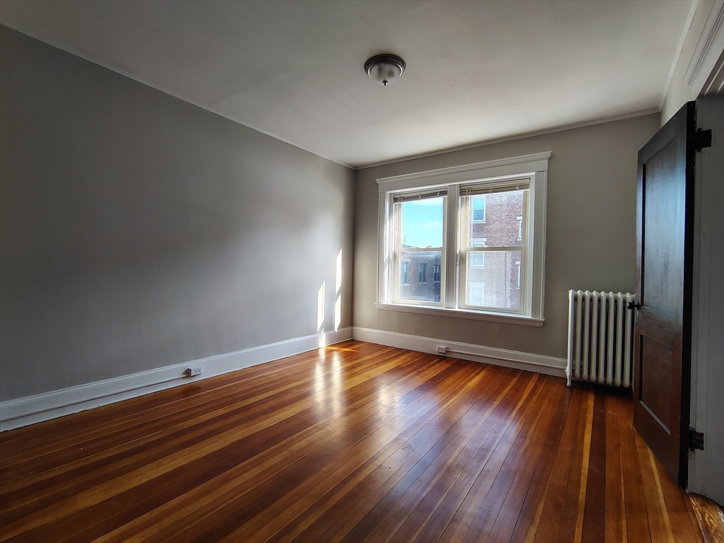 1 Harbor Street, Unit 3 Salem, MA 01970 - Photo 8 of 10 a view of an empty room with wooden floor and a window