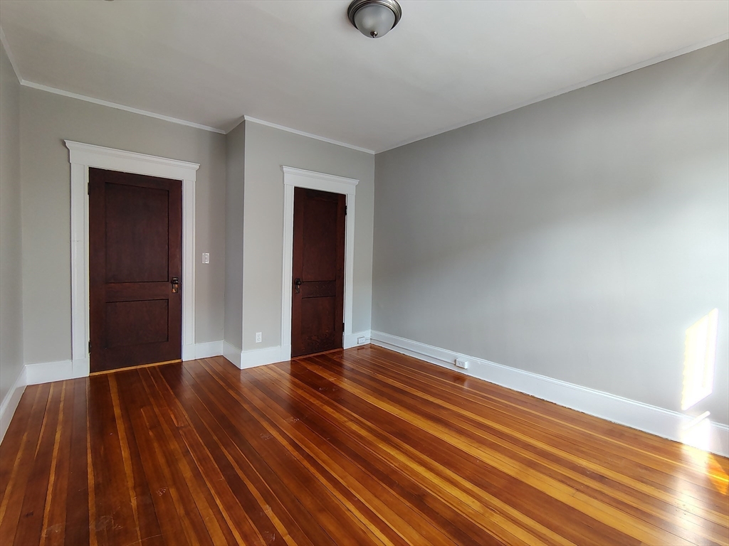 1 Harbor Street, Unit 3 Salem, MA 01970 - Photo 9 of 10 a view of an empty room with wooden floor