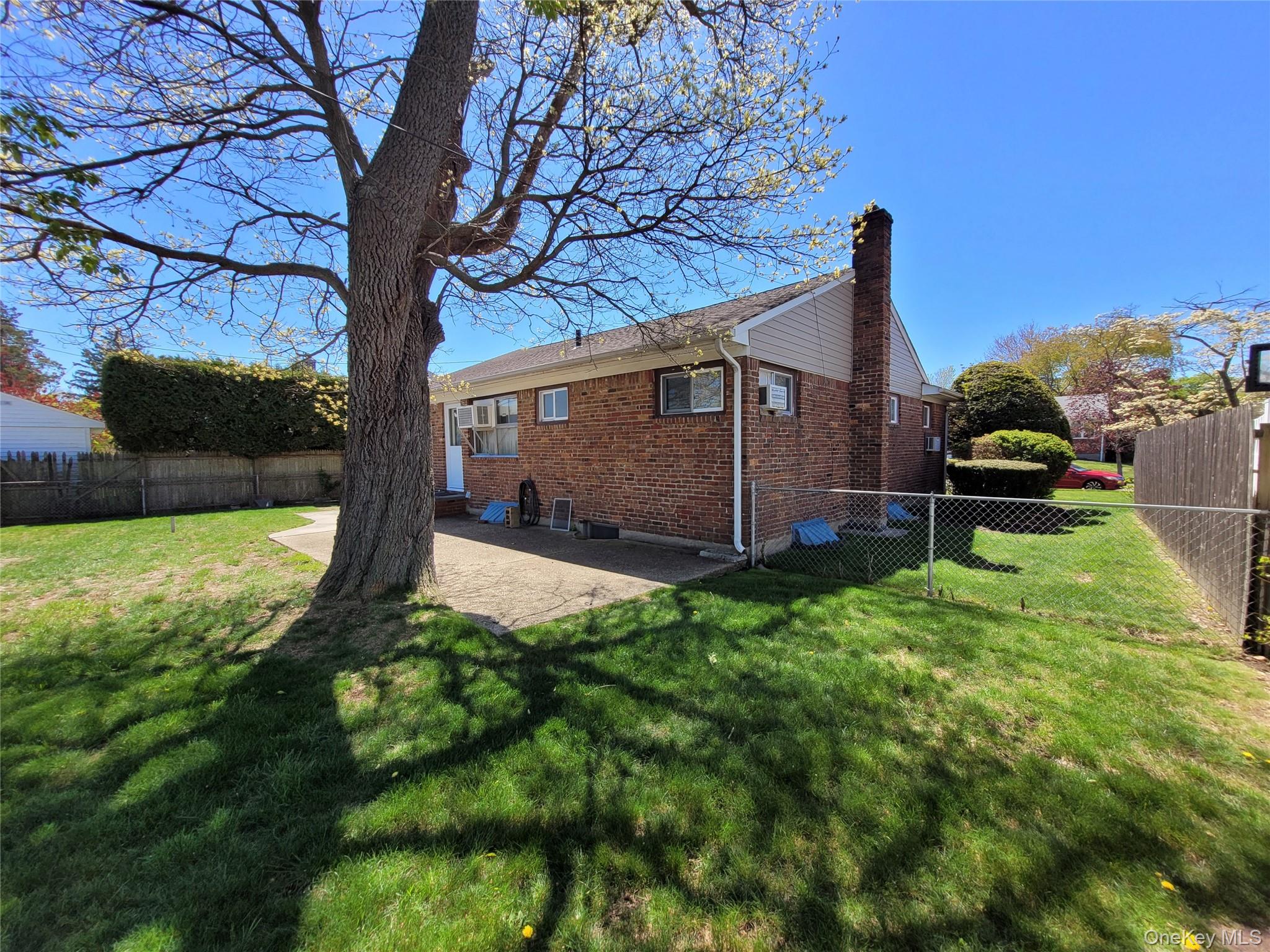 12 Clark Street Plainview, NY 11803 - Photo 3 of 14 a view of a backyard with garden