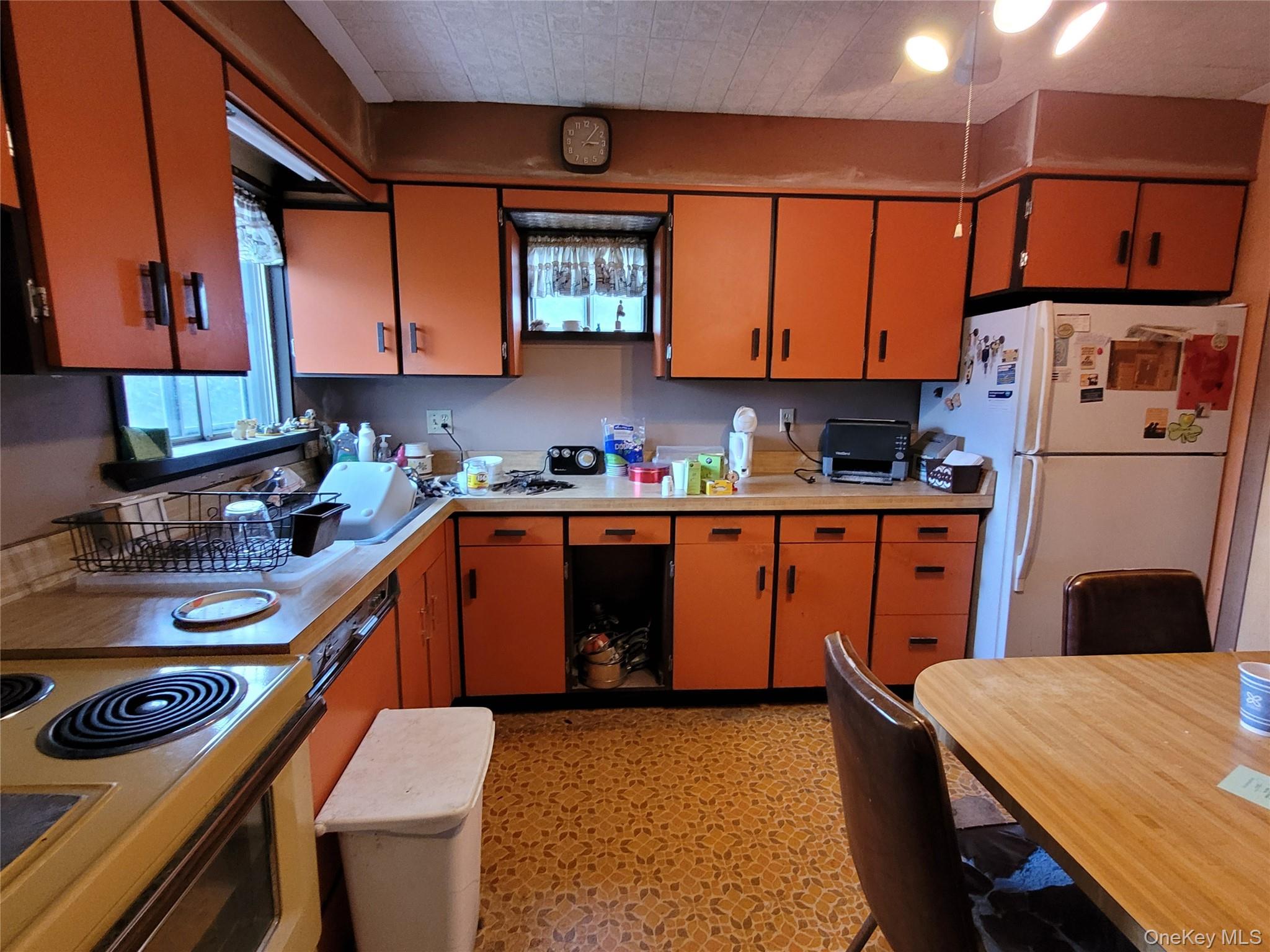 12 Clark Street Plainview, NY 11803 - Photo 7 of 14 a kitchen with stainless steel appliances granite countertop a sink stove and refrigerator
