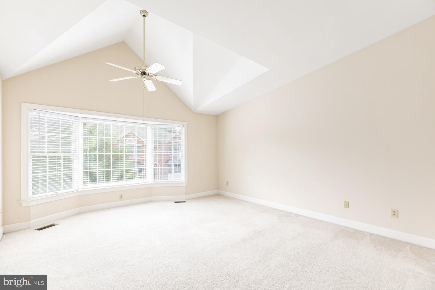 8165 Madrillon Court Vienna, VA 22182 - Photo 16 of 33 an empty room with a ceiling fan and windows