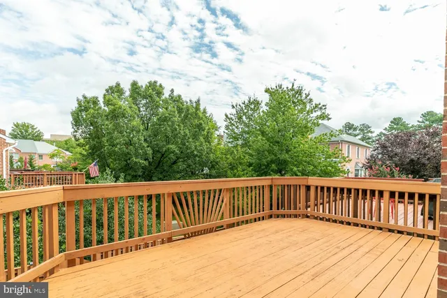 a balcony with wooden floor and fence