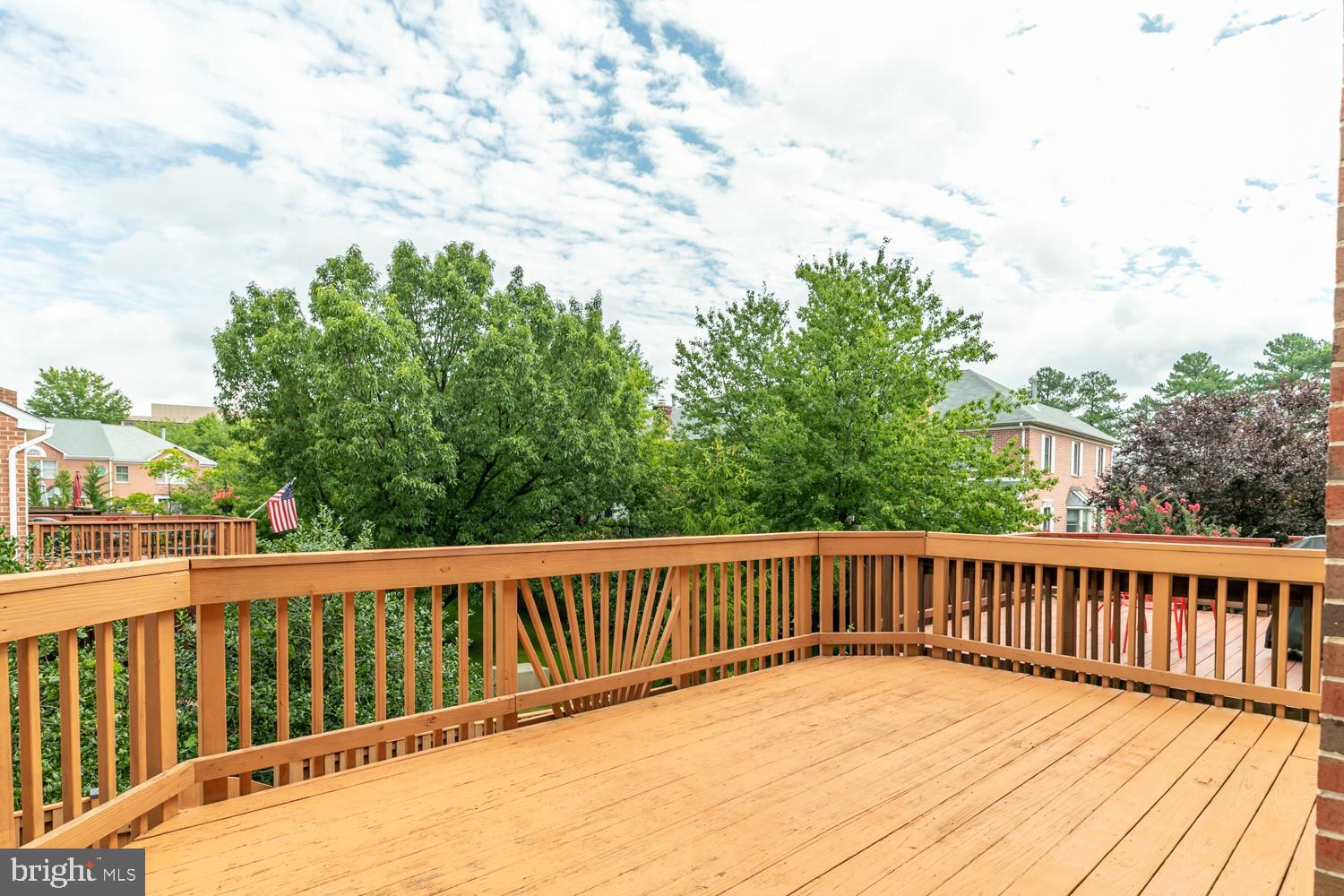 8165 Madrillon Court Vienna, VA 22182 - Photo 2 of 33 a balcony with wooden floor and fence