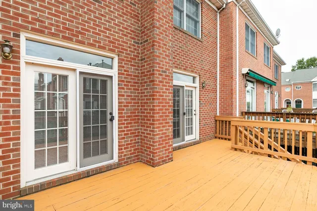 a view of a brick house with large windows