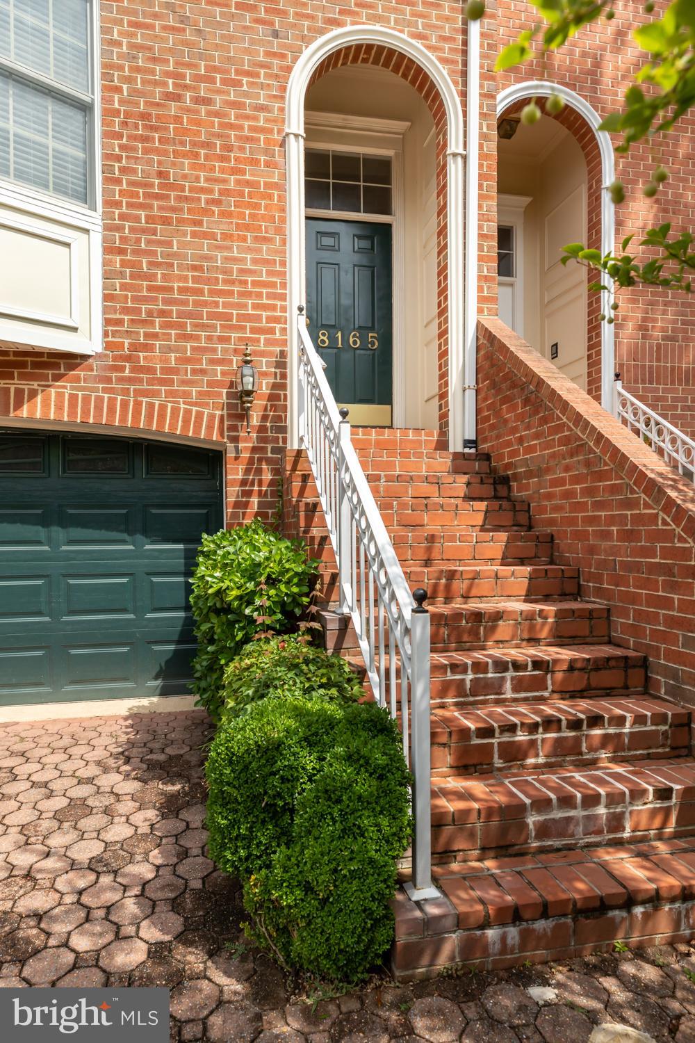 8165 Madrillon Court Vienna, VA 22182 - Photo 32 of 33 a view of a brick house with large windows