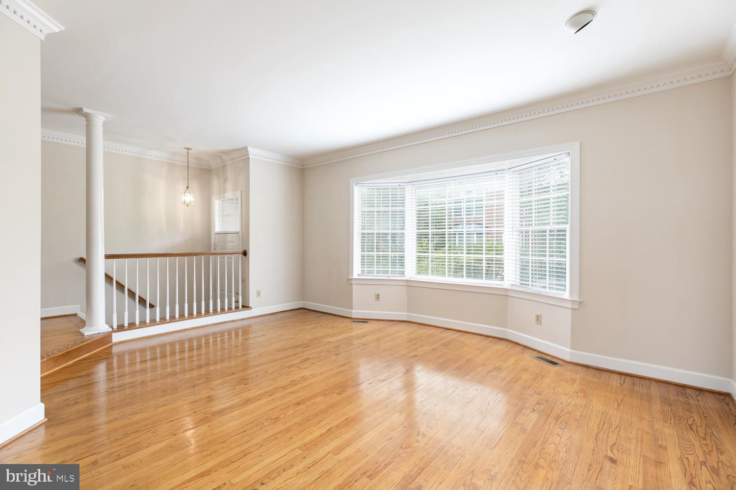 8165 Madrillon Court Vienna, VA 22182 - Photo 4 of 33 a view of an empty room with wooden floor and a window