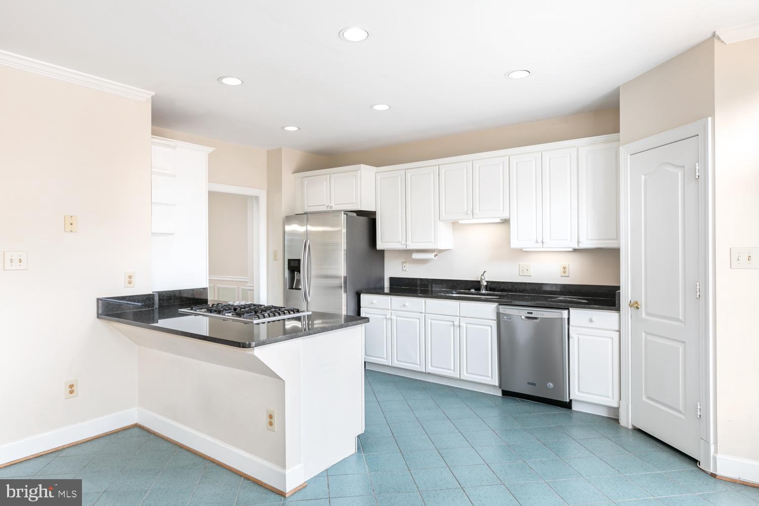 8165 Madrillon Court Vienna, VA 22182 - Photo 9 of 33 a kitchen with stainless steel appliances granite countertop a sink stove and refrigerator