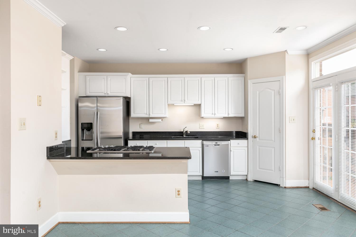 8165 Madrillon Court Vienna, VA 22182 - Photo 10 of 33 a kitchen with stainless steel appliances granite countertop a stove a sink and a refrigerator