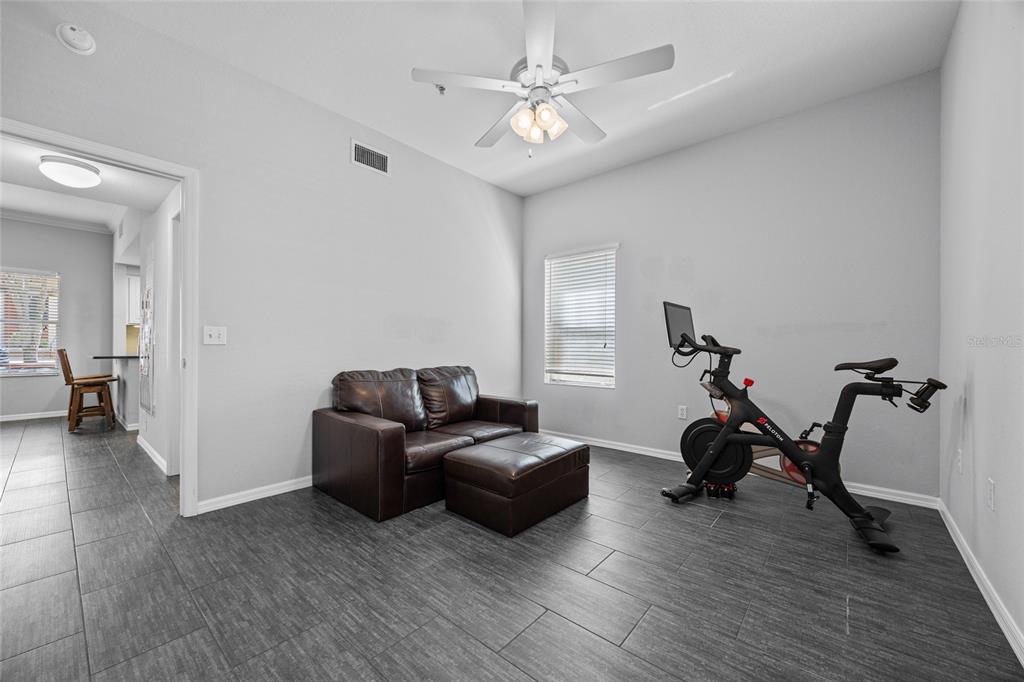 5141 Southwest 91st Way, Unit I102 Gainesville, FL 32608 - Photo 14 of 25 a living room with furniture and a wooden floor
