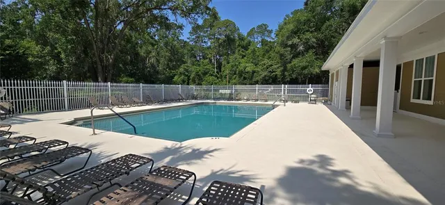 a view of a swimming pool with a patio