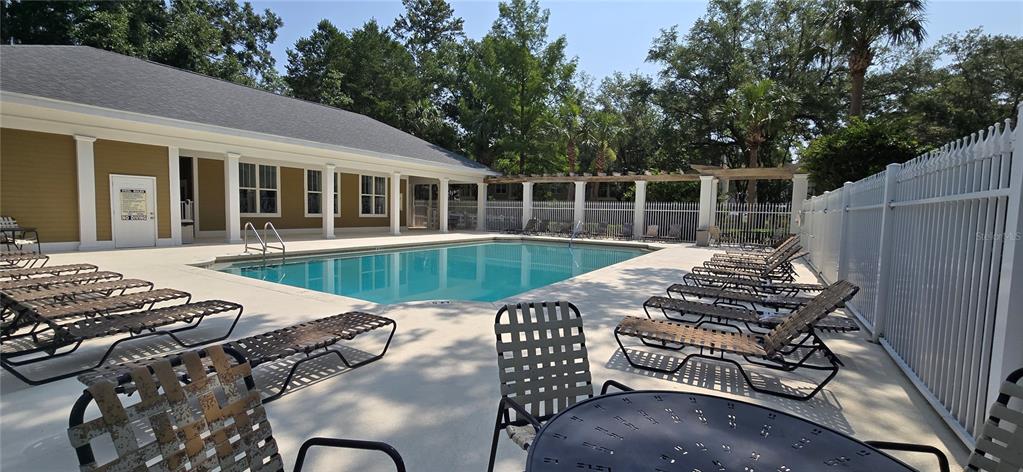 5141 Southwest 91st Way, Unit I102 Gainesville, FL 32608 - Photo 25 of 25 a view of a patio with table and chairs with wooden floor and fence