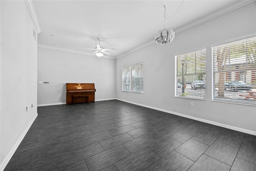 5141 Southwest 91st Way, Unit I102 Gainesville, FL 32608 - Photo 6 of 25 an empty room with windows and ceiling fan