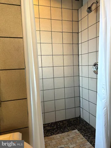 a bedroom with a bed and a mirror