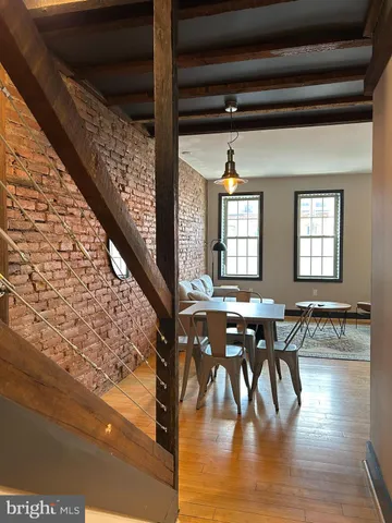 a view of a dining room with furniture window and wooden floor