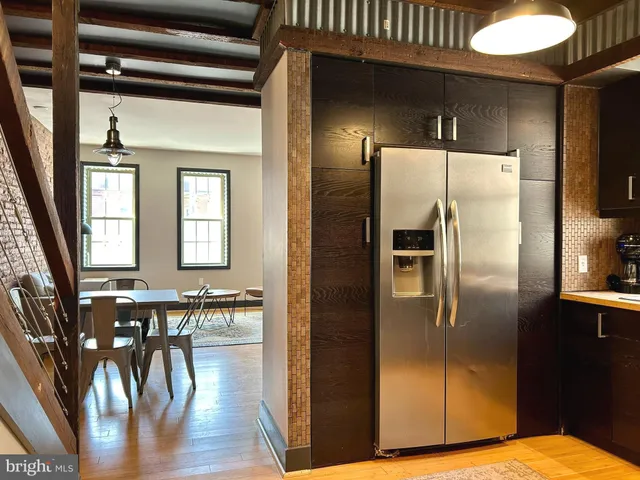 a kitchen with stainless steel appliances granite countertop a refrigerator a stove and a microwave