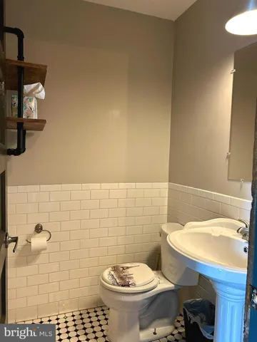 a bathroom with a toilet a sink and a window