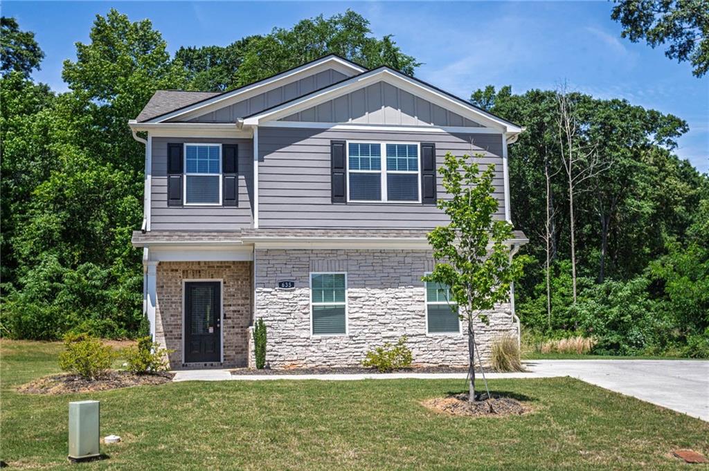 a front view of a house with a yard
