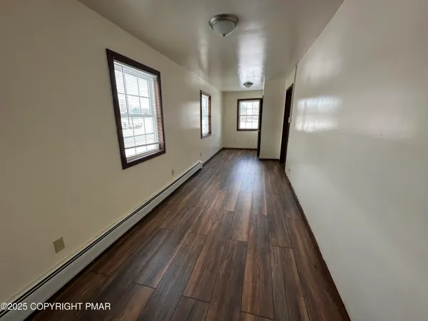 a view of gallery with wooden floor
