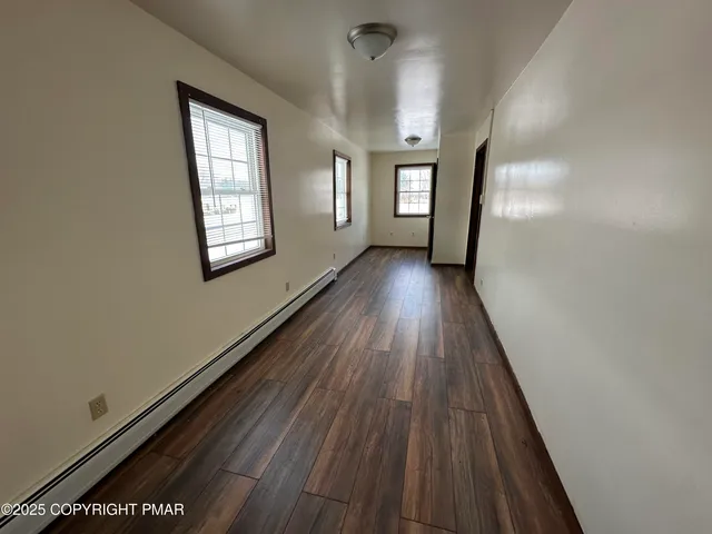 a view of gallery with wooden floor