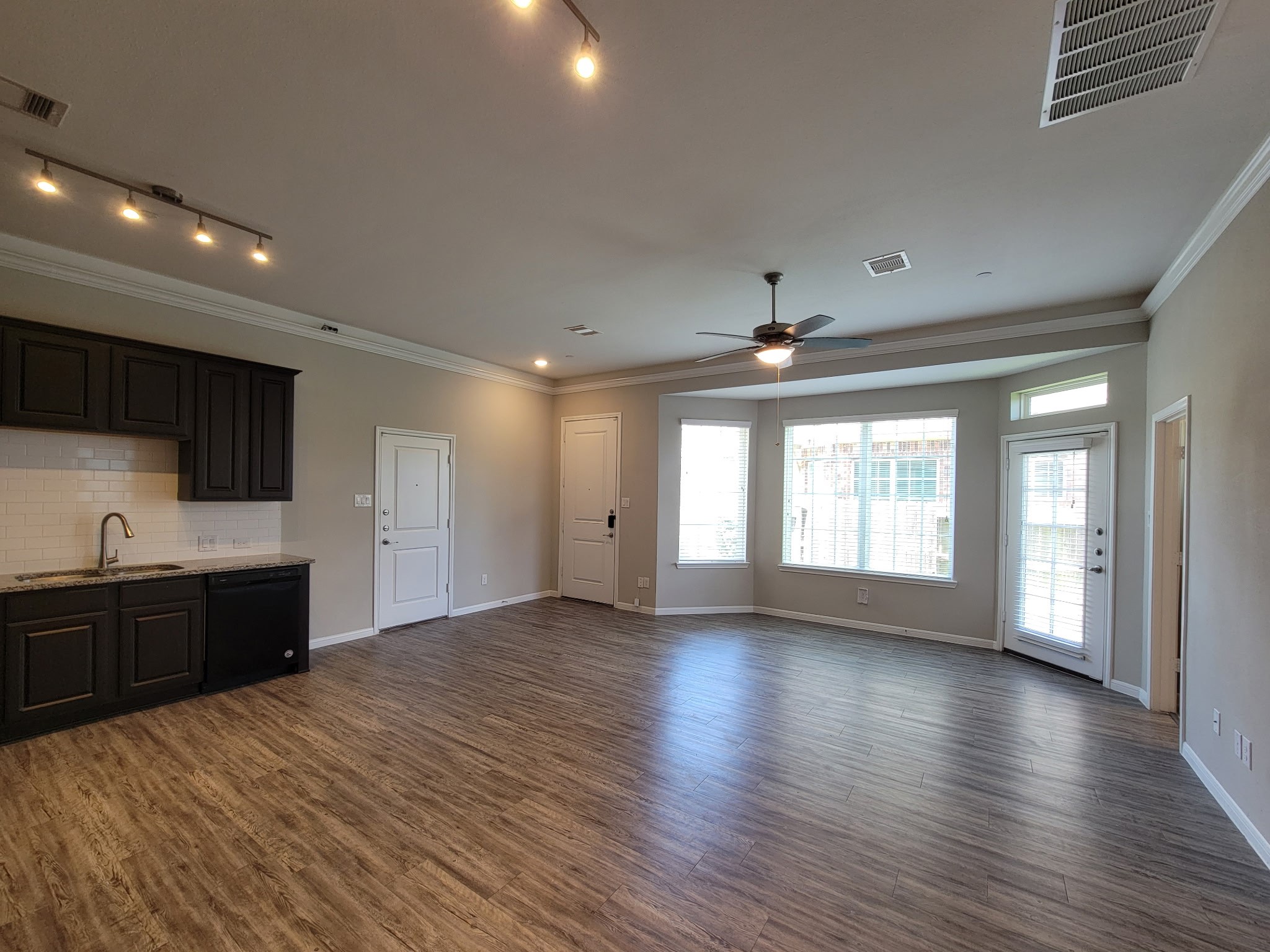 7486 Woo Street Pearland, TX 77584 - Photo 3 of 15 wooden floor in an empty room with a kitchen