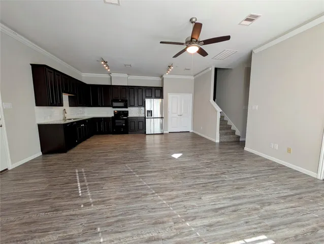 a large kitchen with kitchen island a sink stainless steel appliances and cabinets