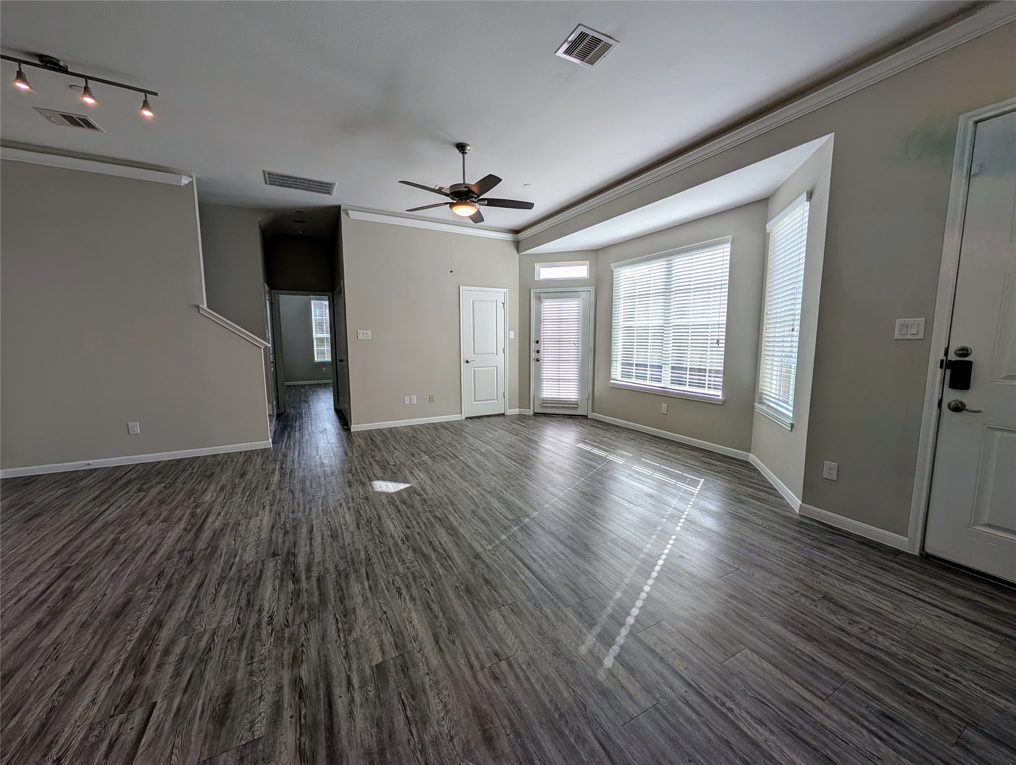 7486 Woo Street Pearland, TX 77584 - Photo 8 of 15 a view of an empty room with wooden floor and a window