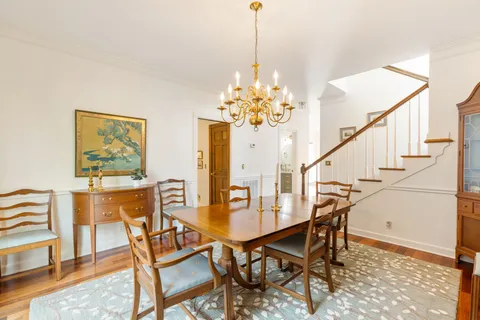 a dining room with furniture and chandelier