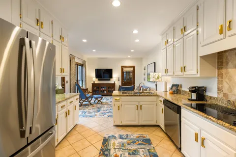 a kitchen with stainless steel appliances a stove a sink and a refrigerator