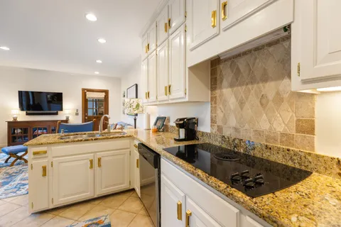 a kitchen that has a sink and a stove in it