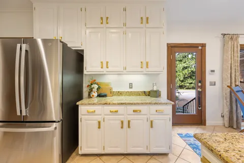 a kitchen with appliances a stove and a refrigerator