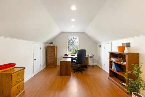 a view of a livingroom with furniture and a workspace