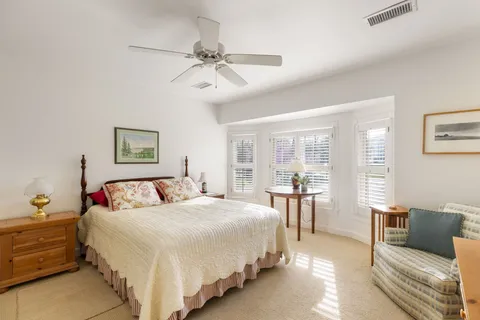 a spacious bedroom with a bed and a chandelier
