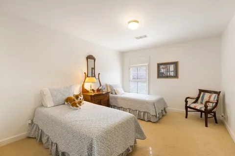 a bedroom with two beds and a window