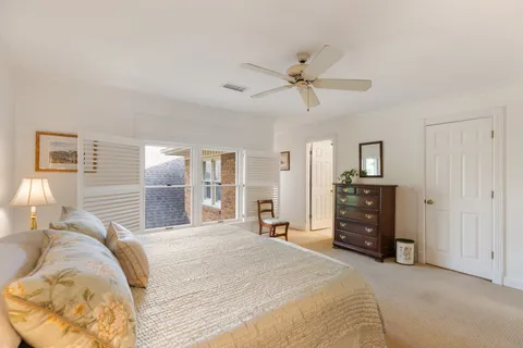a spacious bedroom with a bed and a chandelier