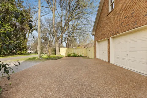a view of a house with a yard and garage