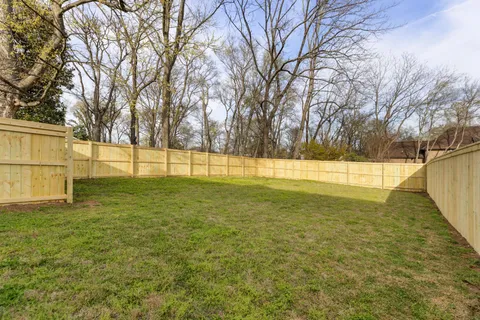 a view of yard with tree in the background