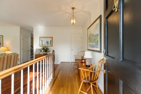 a view of a room with wooden floor windows and a chandelier