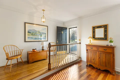 a view of a bedroom with furniture wooden floor and window