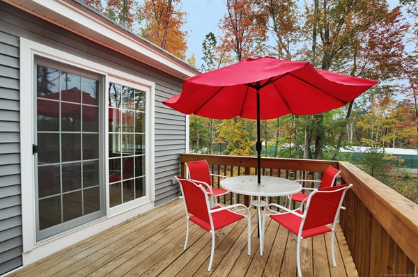 78 Groton Road Shirley, MA 01464 - Photo 24 of 30 a patio with wooden floor a yard a table and chairs