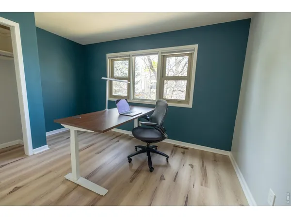 a workspace with furniture and wooden floor