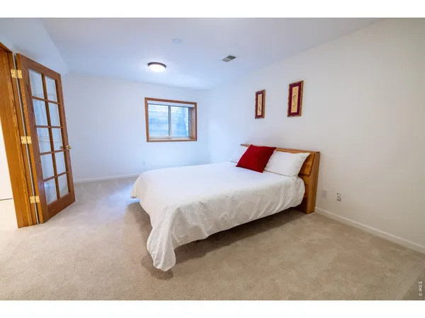 a bedroom with a bed and a large window