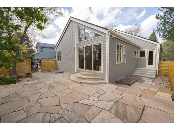 a view of house with backyard of the house