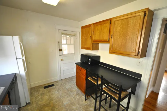 a kitchen with stainless steel appliances a sink and a refrigerator