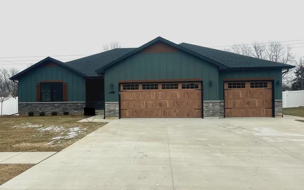 a front view of a house with a yard and garage