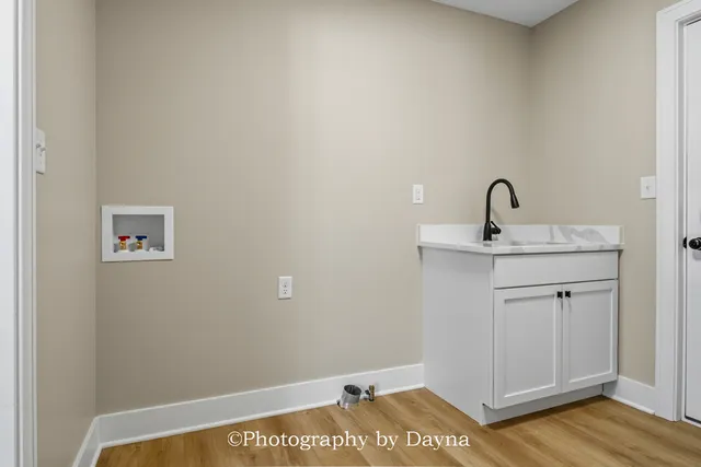 a view of a room with wooden floor
